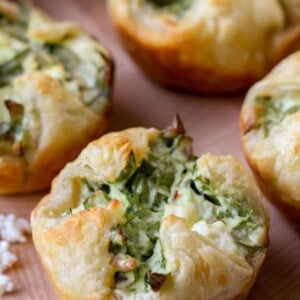 A few spinach cheese puffs on a tray.