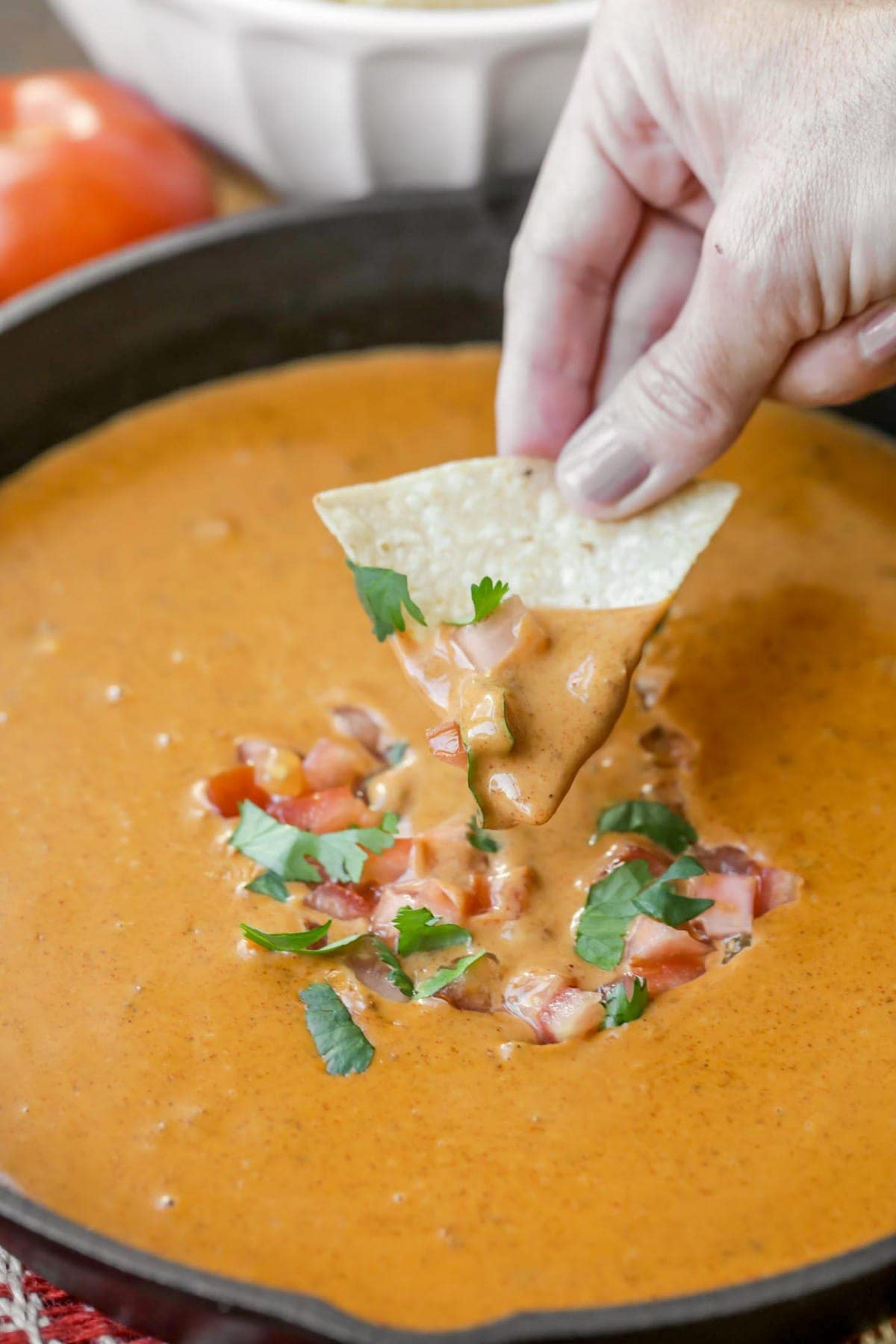 Chili's skillet Queso topped with cilantro and tomatoes.