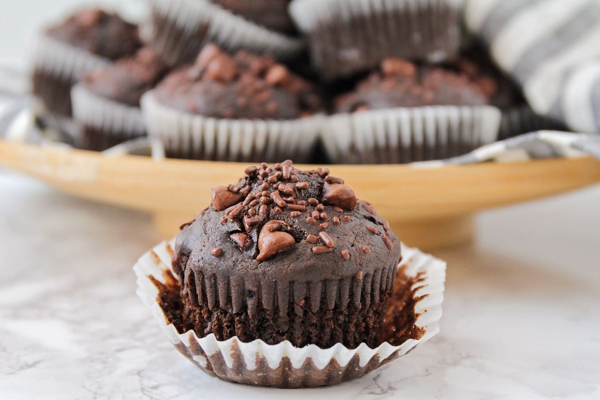 One chocolate muffin with the wrapper peeled off.