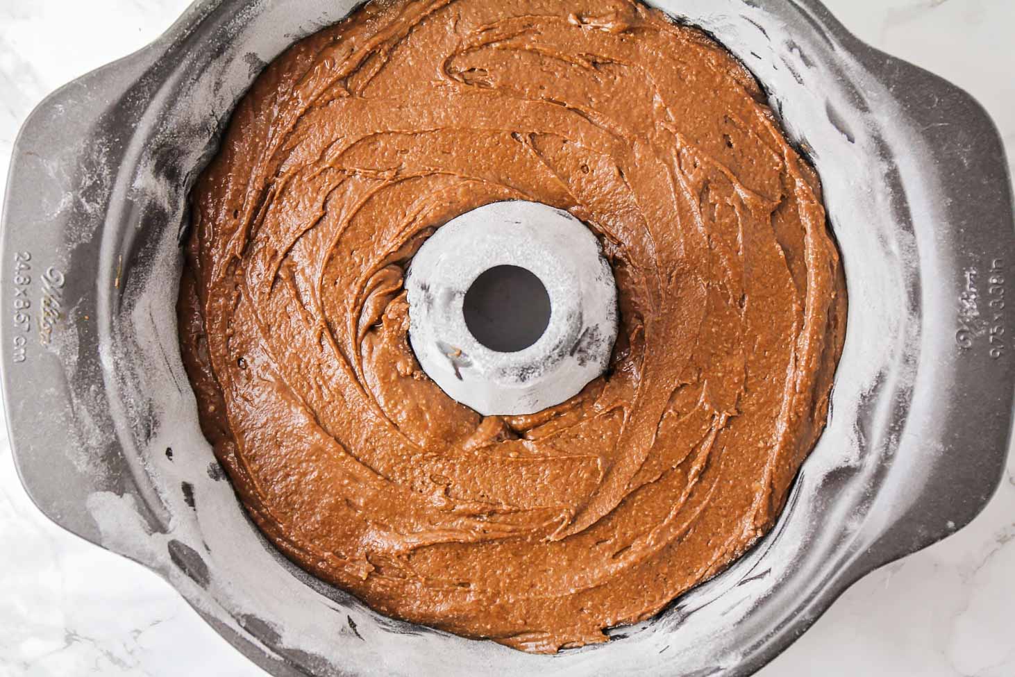 Chocolate bundt cake batter in a bundt pan ready for baking.