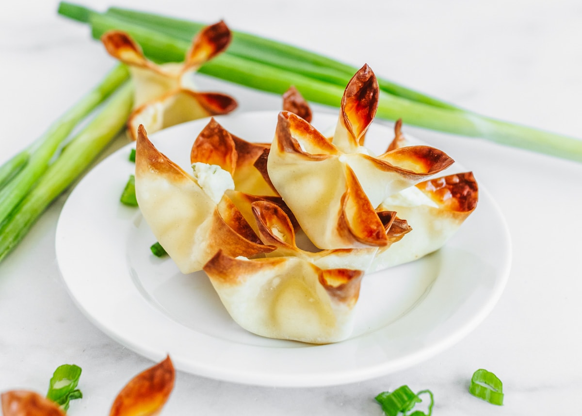 Asian Appetizers - Baked Cream Cheese Rangoons on a white plate. 