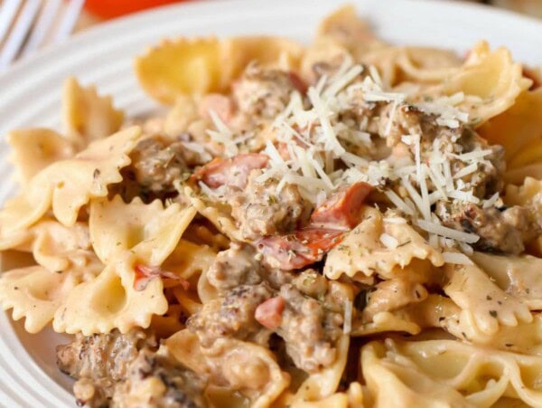 Homemade Italian sausage pasta served on a white plate.
