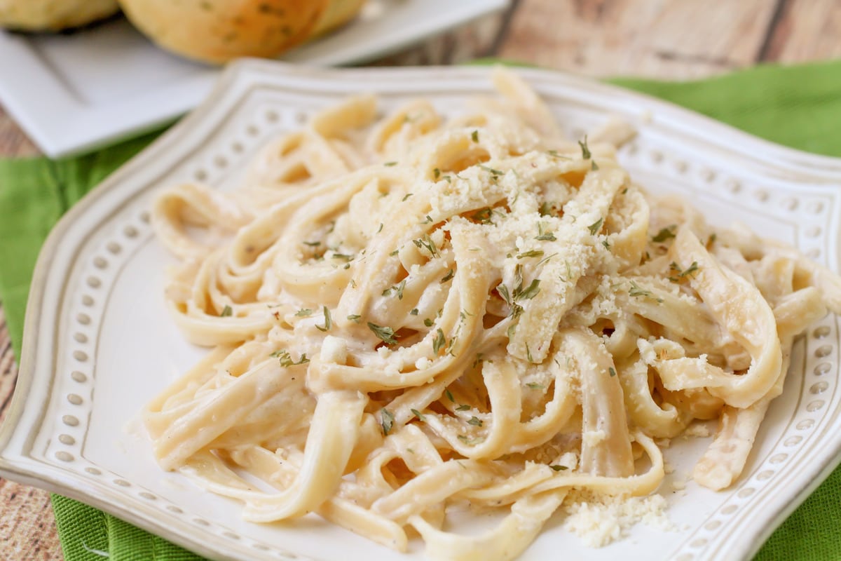 Homemade Fettuccine Alfredo on a white plate.