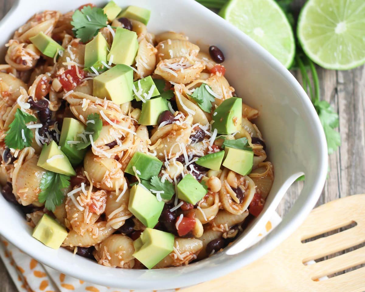 Mexican Christmas food - taco pasta salad topped with fresh avocado and cilantro.