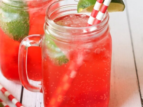 Cherry limeade served in a mason jar.