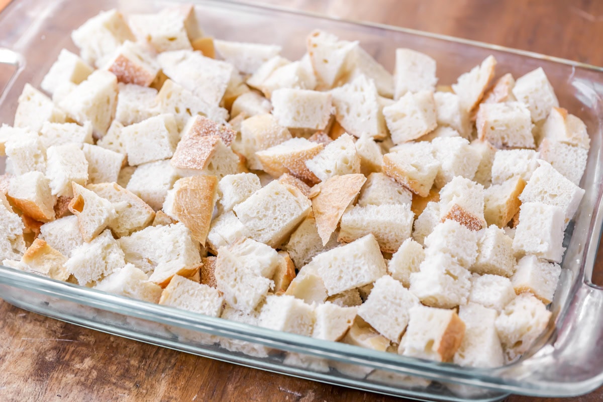 Sourdough bread pieces cut and placed in baking dish. 