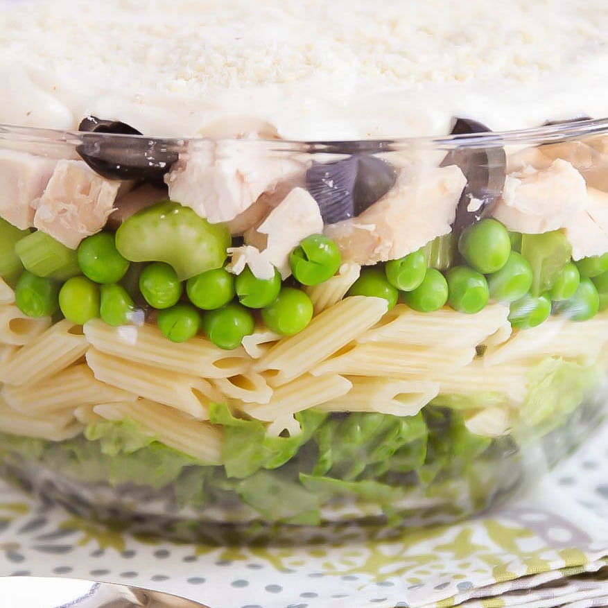 Layered pasta salad in a glass dish