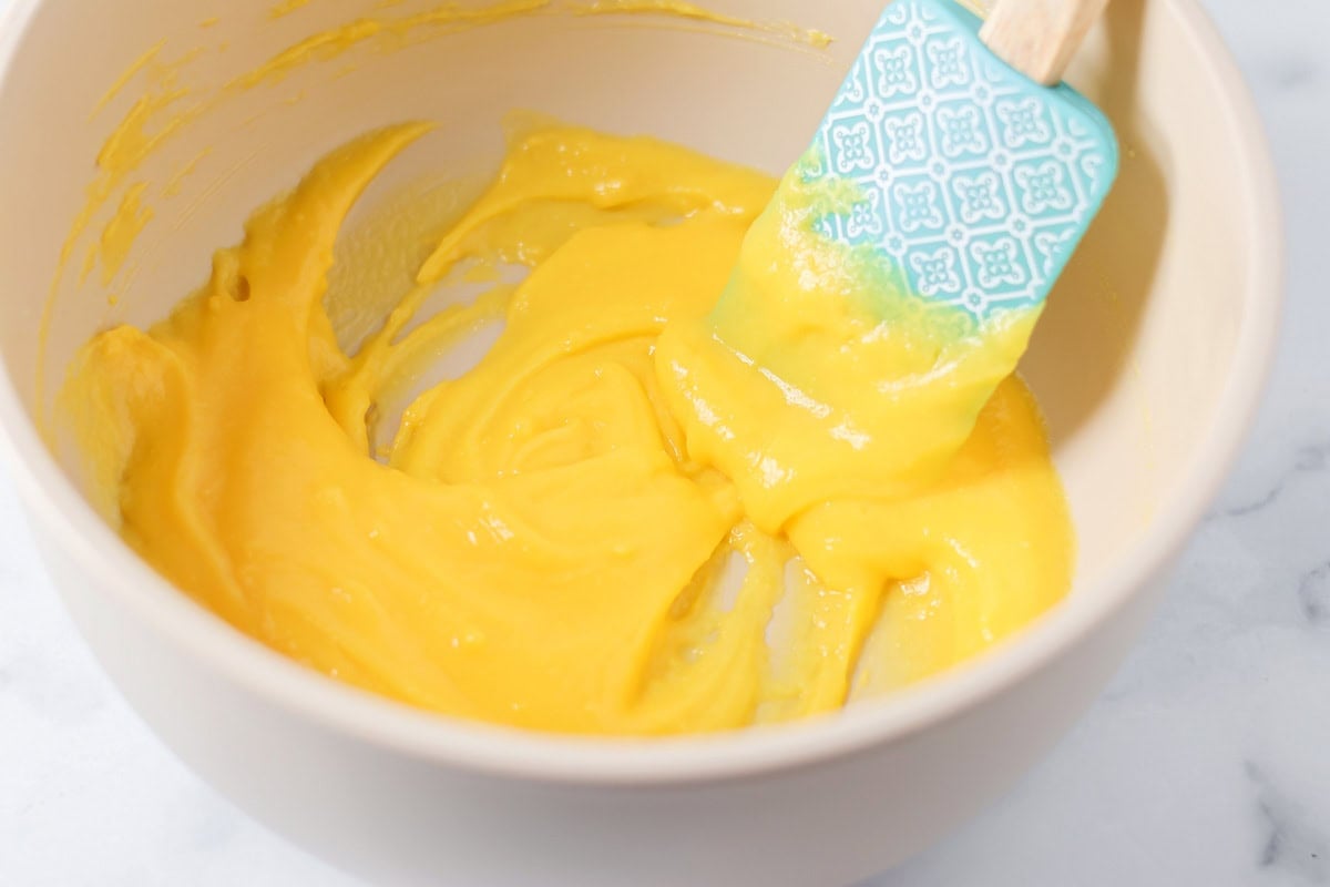 Our 10-minute Snickers salad is a sweet and tart dessert where bright pops of apples perfectly complement chewy chunks of Snickers. Mixing vanilla pudding in a mixing bowl.