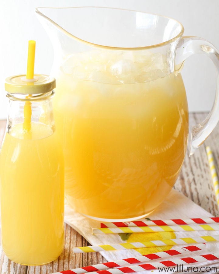 Summer Recipes - Homemade lemonade in a pitcher and a glass bottle with a straw.