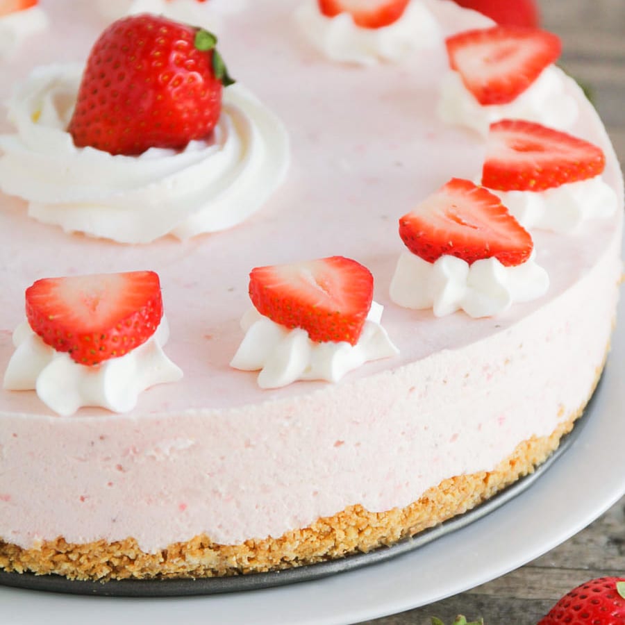 Closeup of fresh strawberries on top of frozen strawberry dessert
