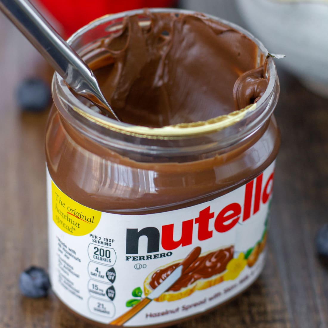 A jar of nutella used for topping mini fruit pizzas.