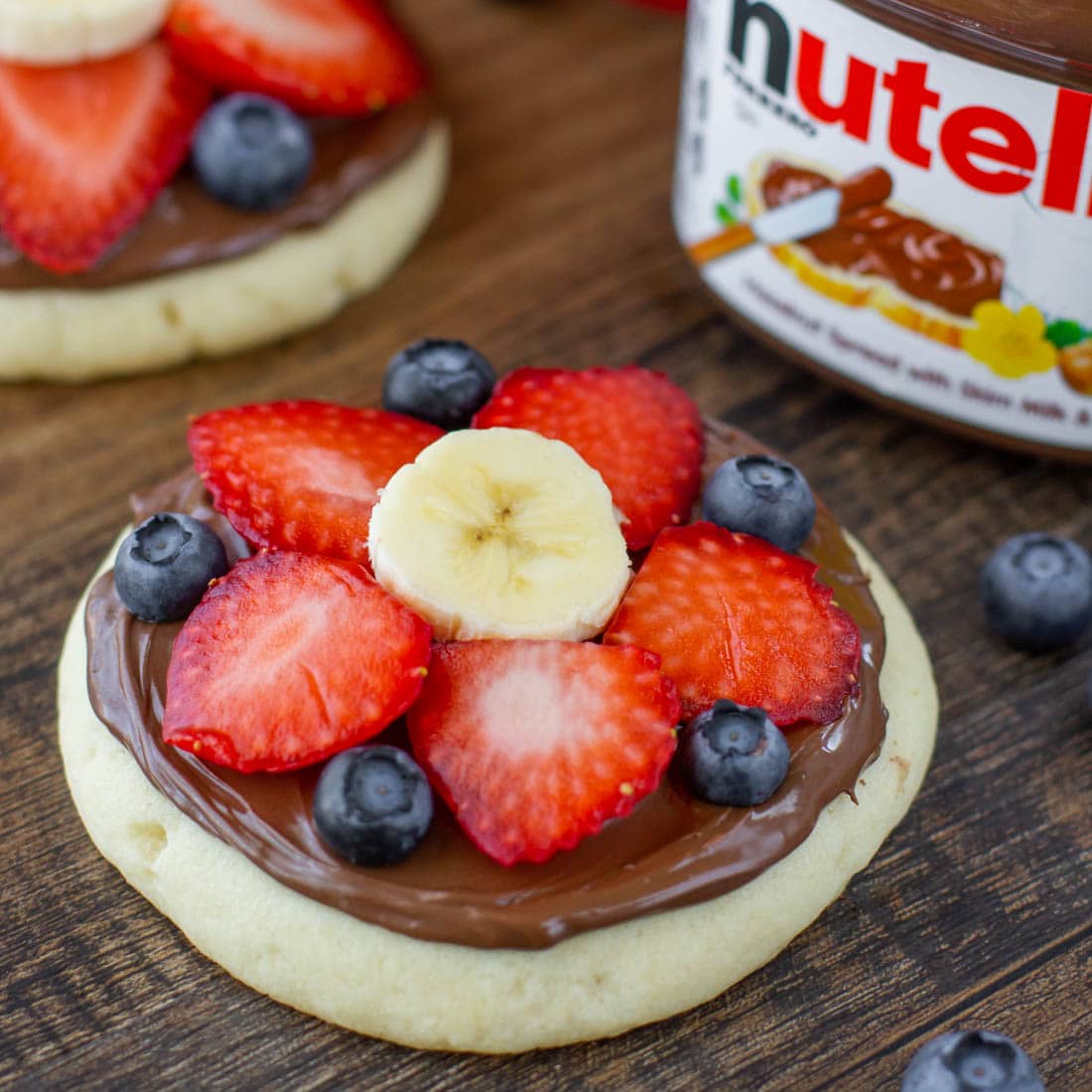 Mini Fruit Pizza topped with nutella and fresh fruit.