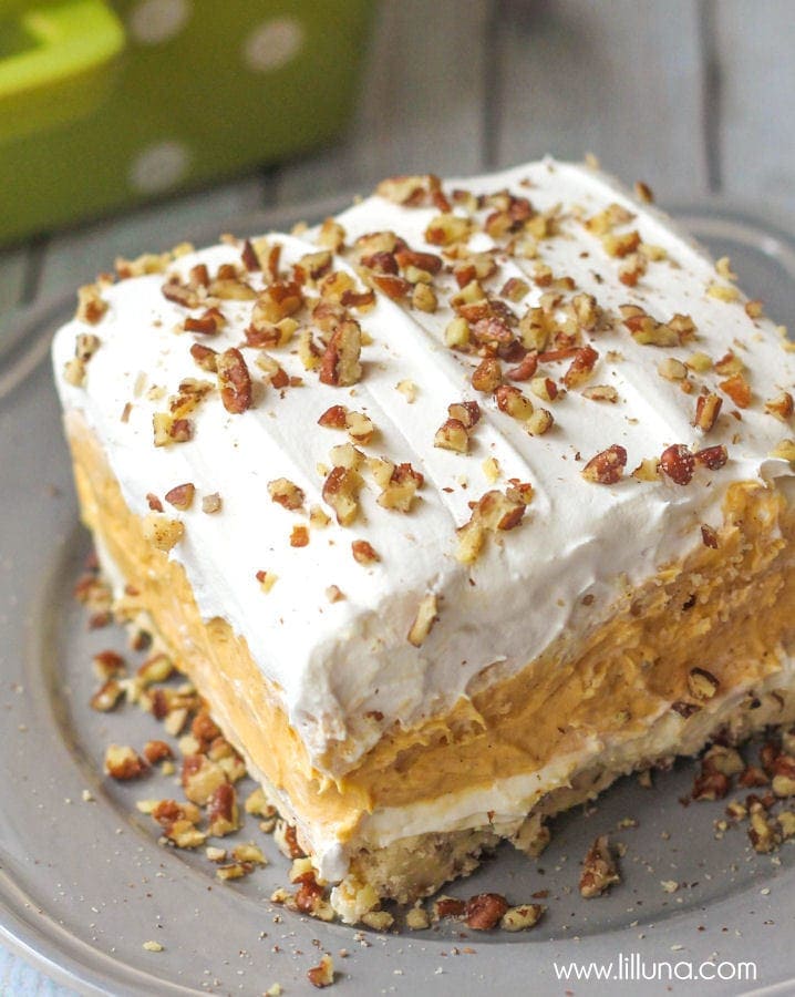 Creamy and Cool Pumpkin Delight with so many delicious layers - everyone will love it! { lilluna.com } Recipe includes whipped topping, pecans, pumpkin spice, pumpkin puree, cream cheese and white chocolate instant pudding mix.