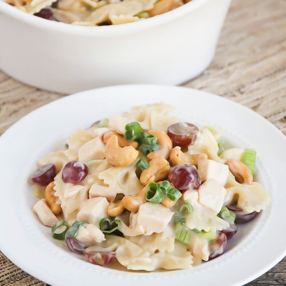 Cashew chicken salad on white plate.