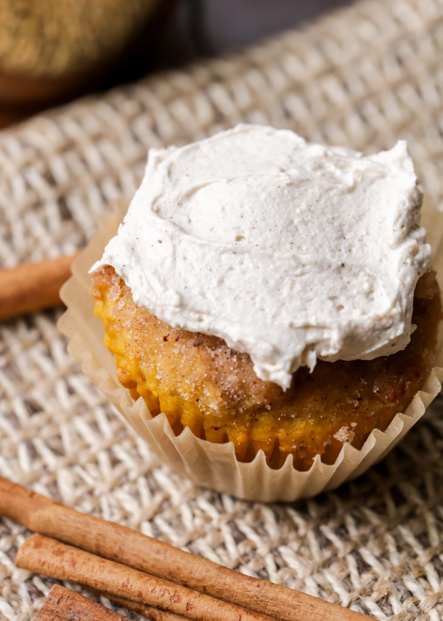 moist pumpkin muffins with buttercream frosting on top