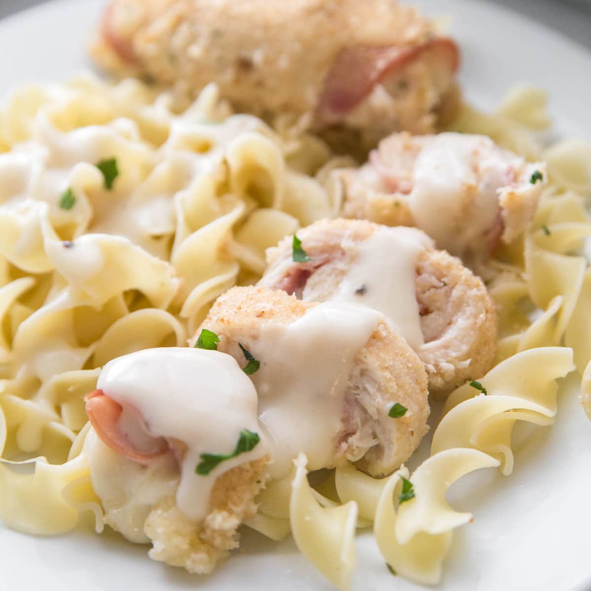 Chicken Breast Recipes - Easy chicken cordon bleu on a plate of pasta.