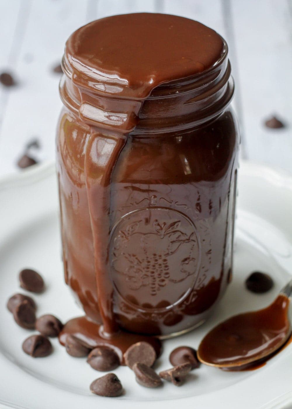 Our favorite hot fudge sauce recipe oozing from jar