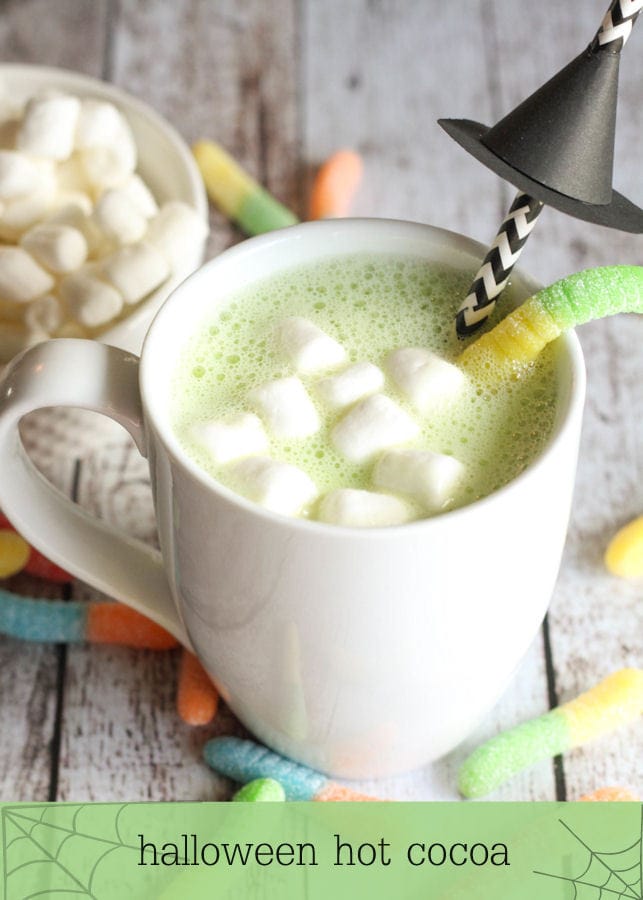 White Chocolate Halloween Hot Cocoa - so delicious and perfect for Halloween! Recipe includes milk, white chocolate chips, green food coloring, marshmallows, & gummy worms.