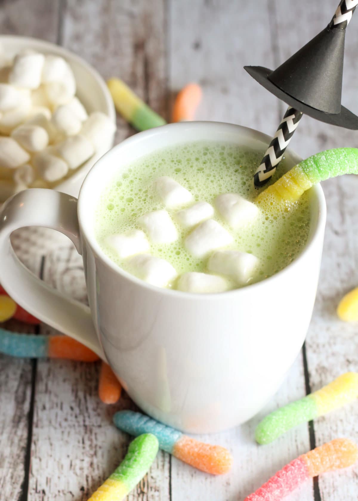 Halloween hot chocolate with marshmallows and a witches hat straw