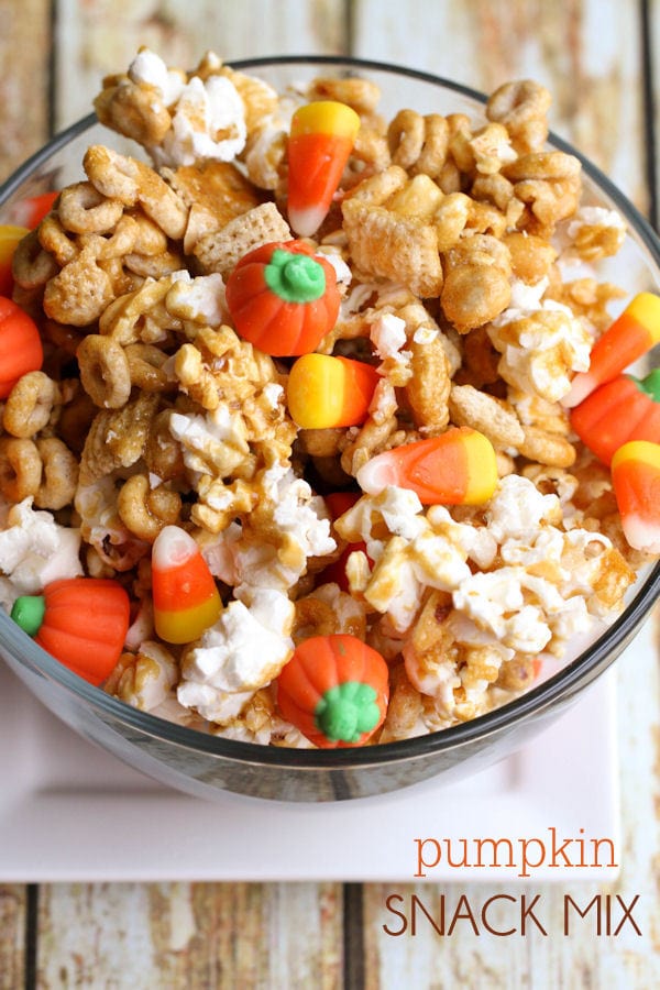 Pumpkin snack mix in a glass bowl.