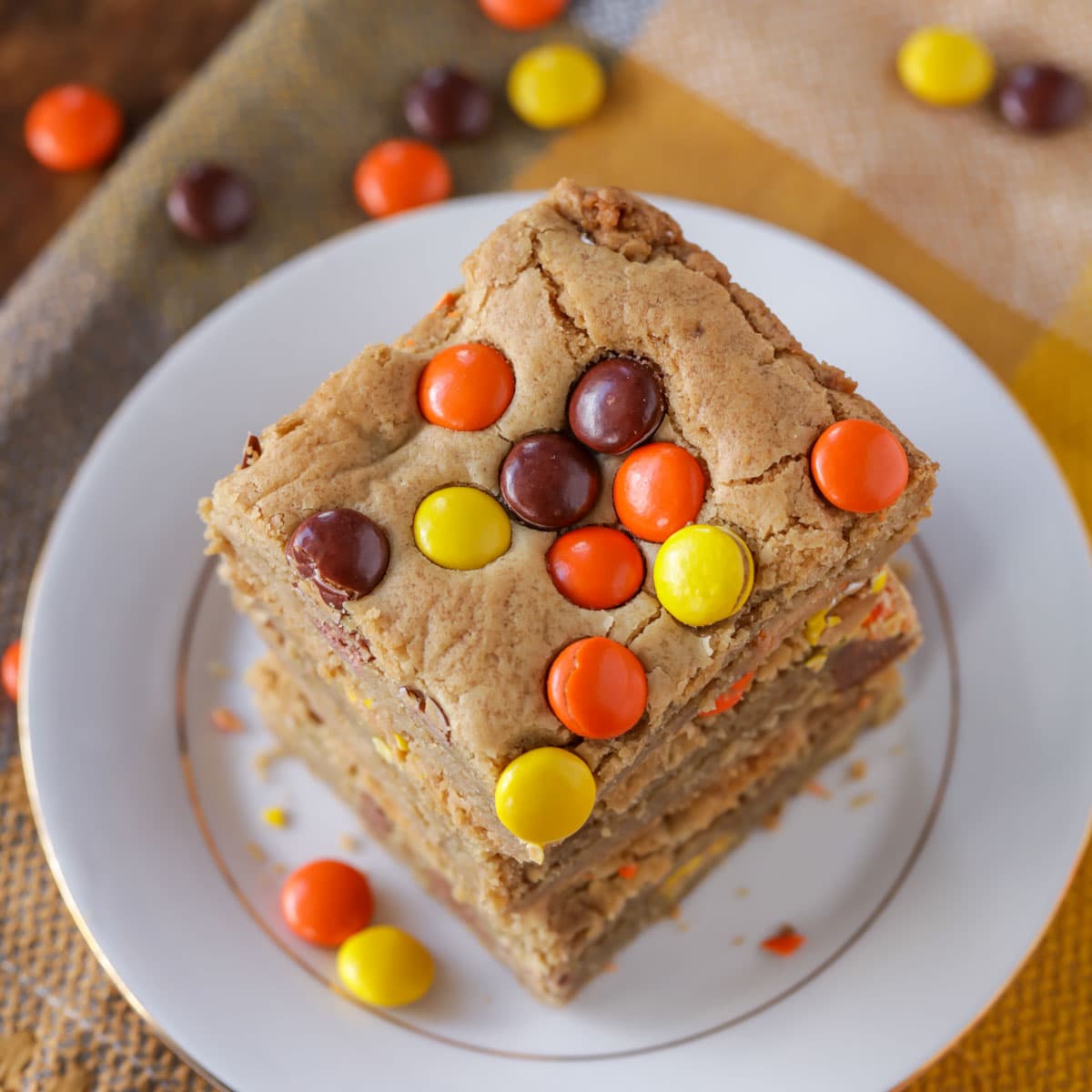 Reese Pieces Bars stacked on a white plate