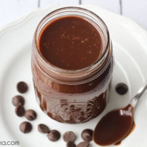 Hot fudge sauce recipe in a mason jar on a white plate.