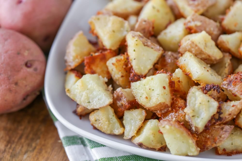 5 Ingredient Recipes - Parmesan potatoes served on a white platter.