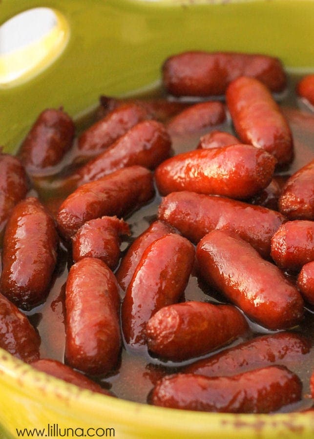 Thanksgiving appetizers - yellow bowl filled with brown sugar beanie weenies.