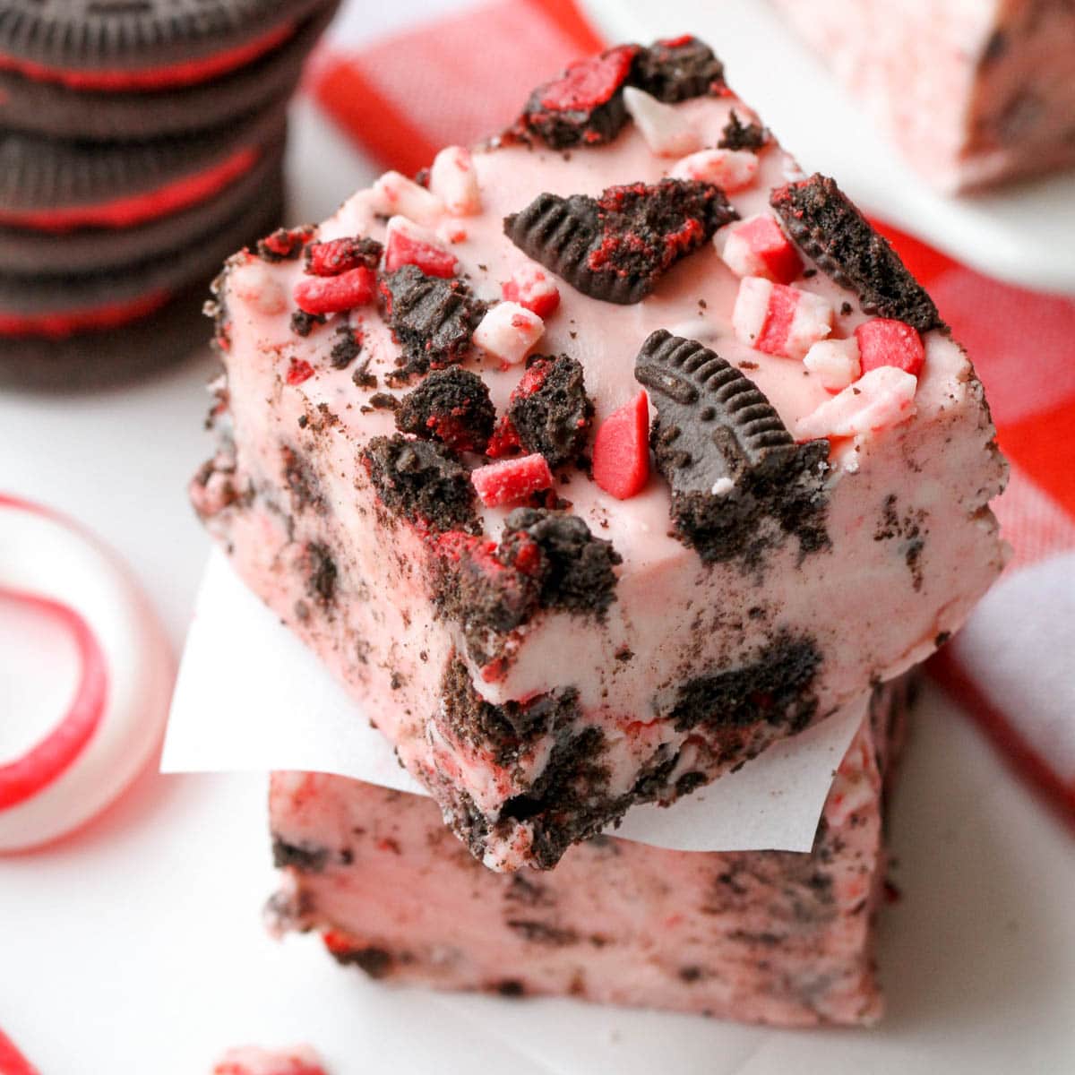 peppermint Oreo fudge sliced and stacked on a white board