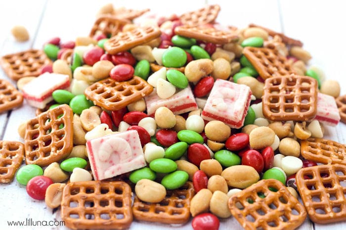 Delicious Christmas Snack Mix poured on a white wooden table