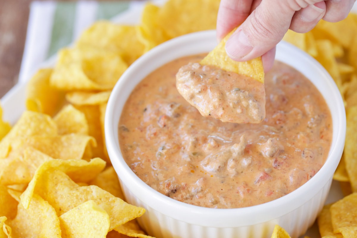 Hamburger Dip served in a white bowl surrounded by tortilla chips.