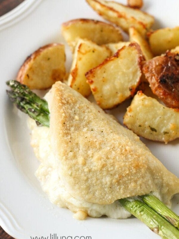 baked parmesan crusted chicken and asparagus on white plate