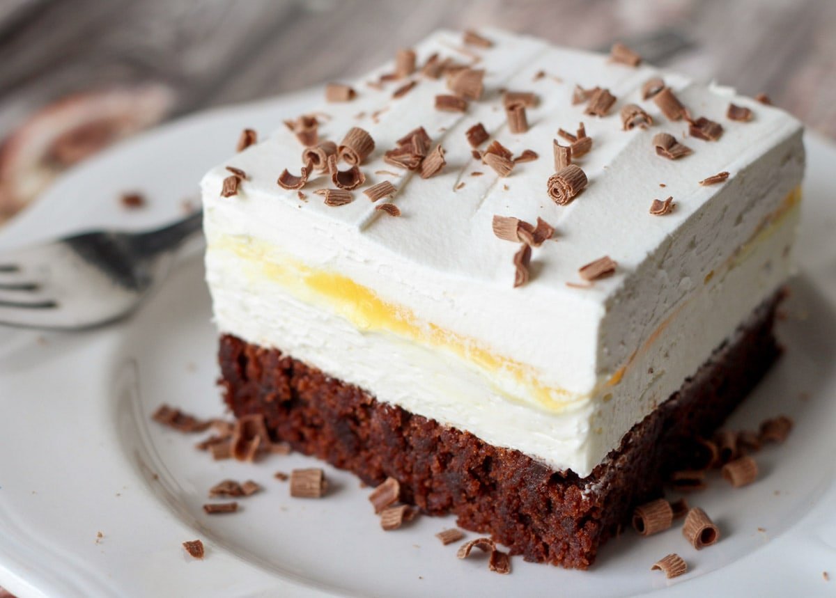 Brownie Delight on a white plate, topped with chocolate shavings.