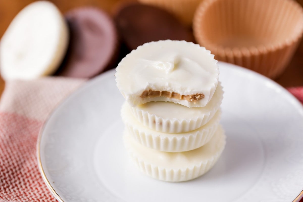 5 Ingredient Recipes - Stack of white chocolate homemade reese's with a bite missing.