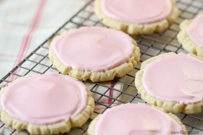 Valentine's Day Desserts - Copycat Swig Sugar cookies with pink frosting on a wire rack. 