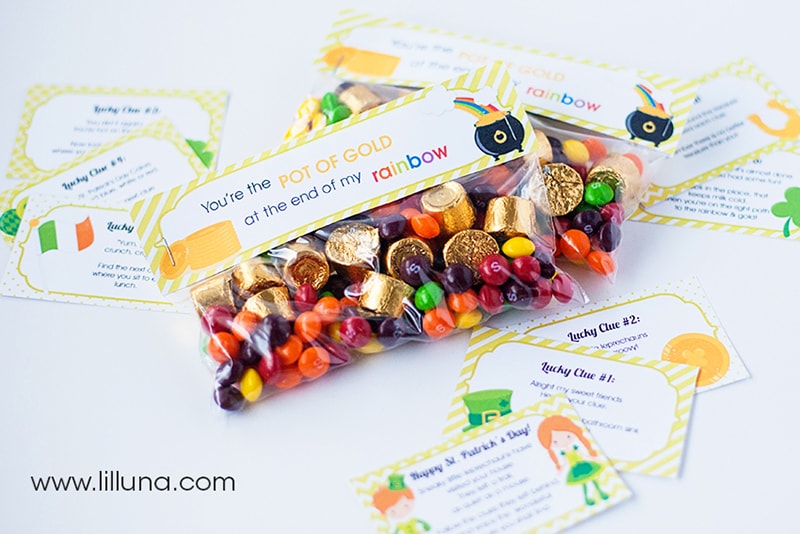Printed out cards for a leprechaun scavenger hunt with a prize of skittles and golden wrapped rolos in a ziploc bag.