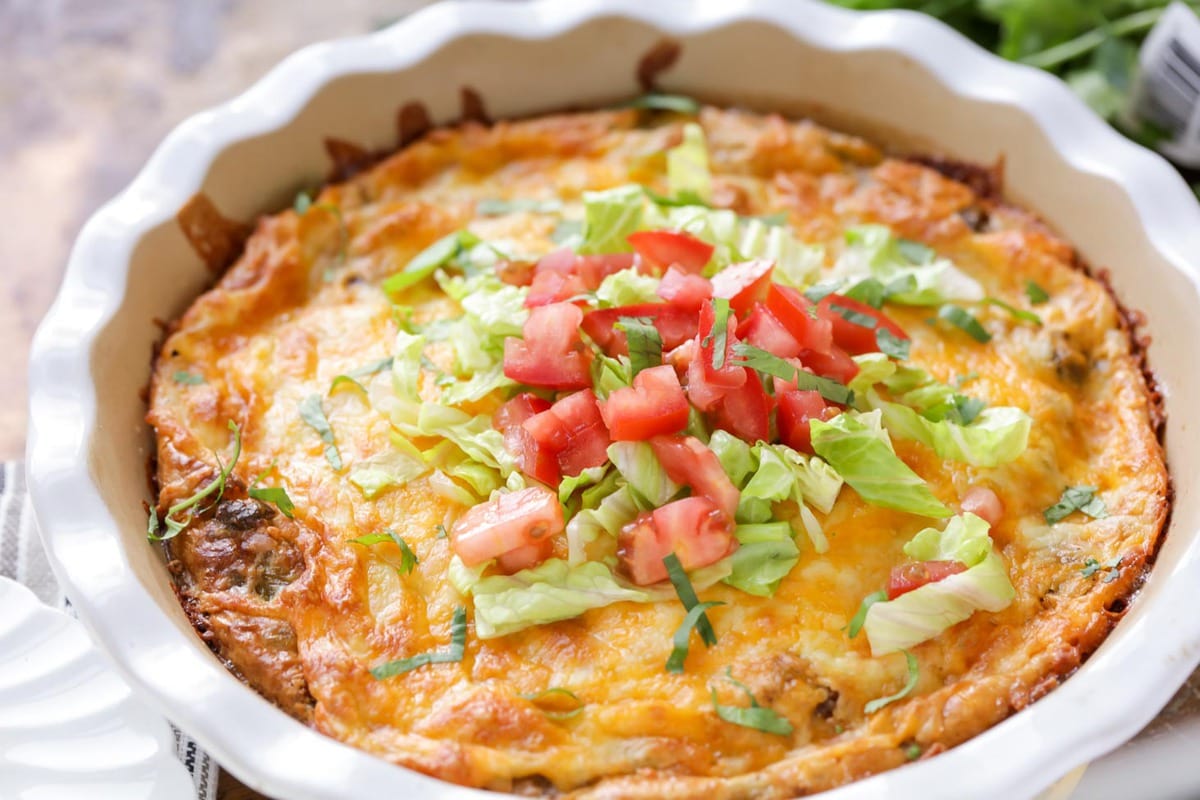 Quick dinner ideas - taco pie topped with fresh tomatoes and lettuce.