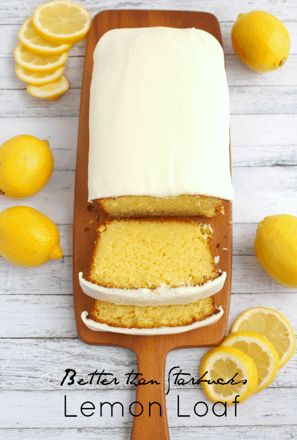 Lemon loaf on a cutting board with lemons