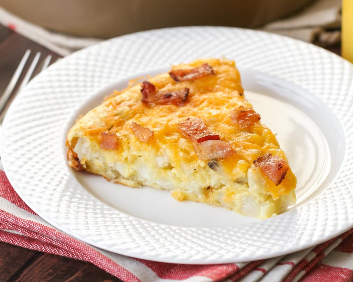 Breakfast casserole recipes - a slice of breakfast pie on a white plate.