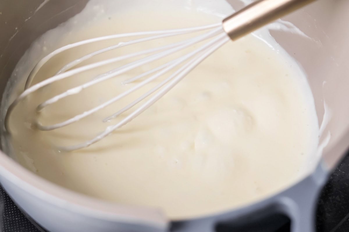Alfredo sauce cooked in pan.