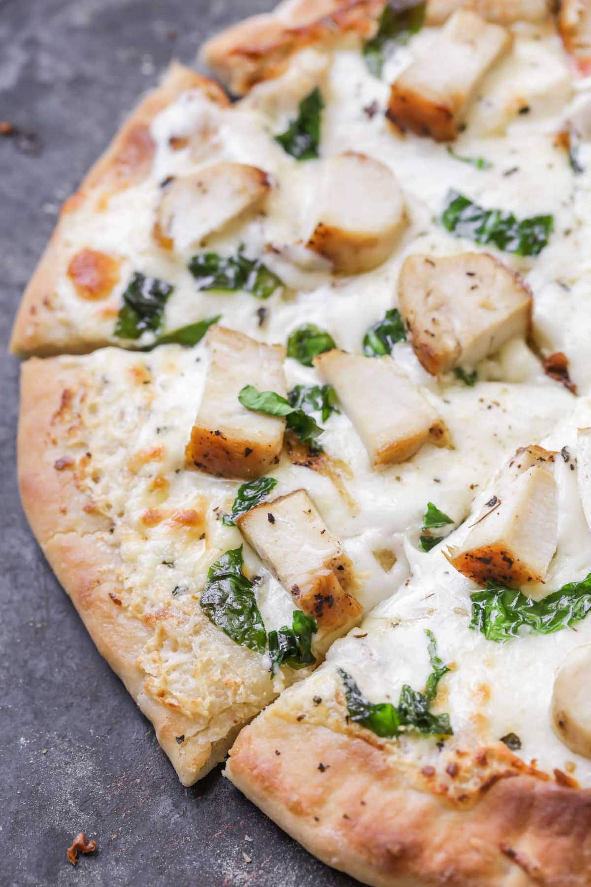 Chicken Alfredo Pizza cut into slices after being baked