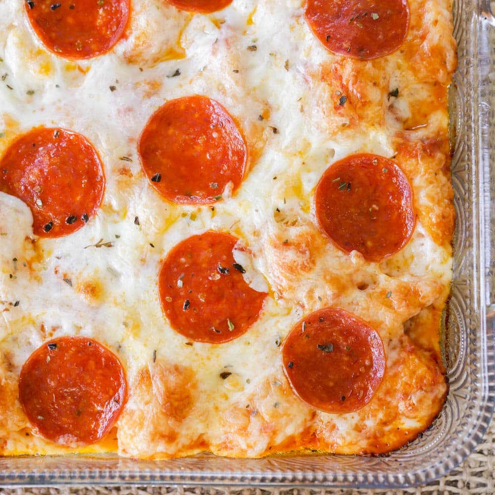 5 Ingredient Recipes - Close up of easy pizza casserole in a glass baking dish.