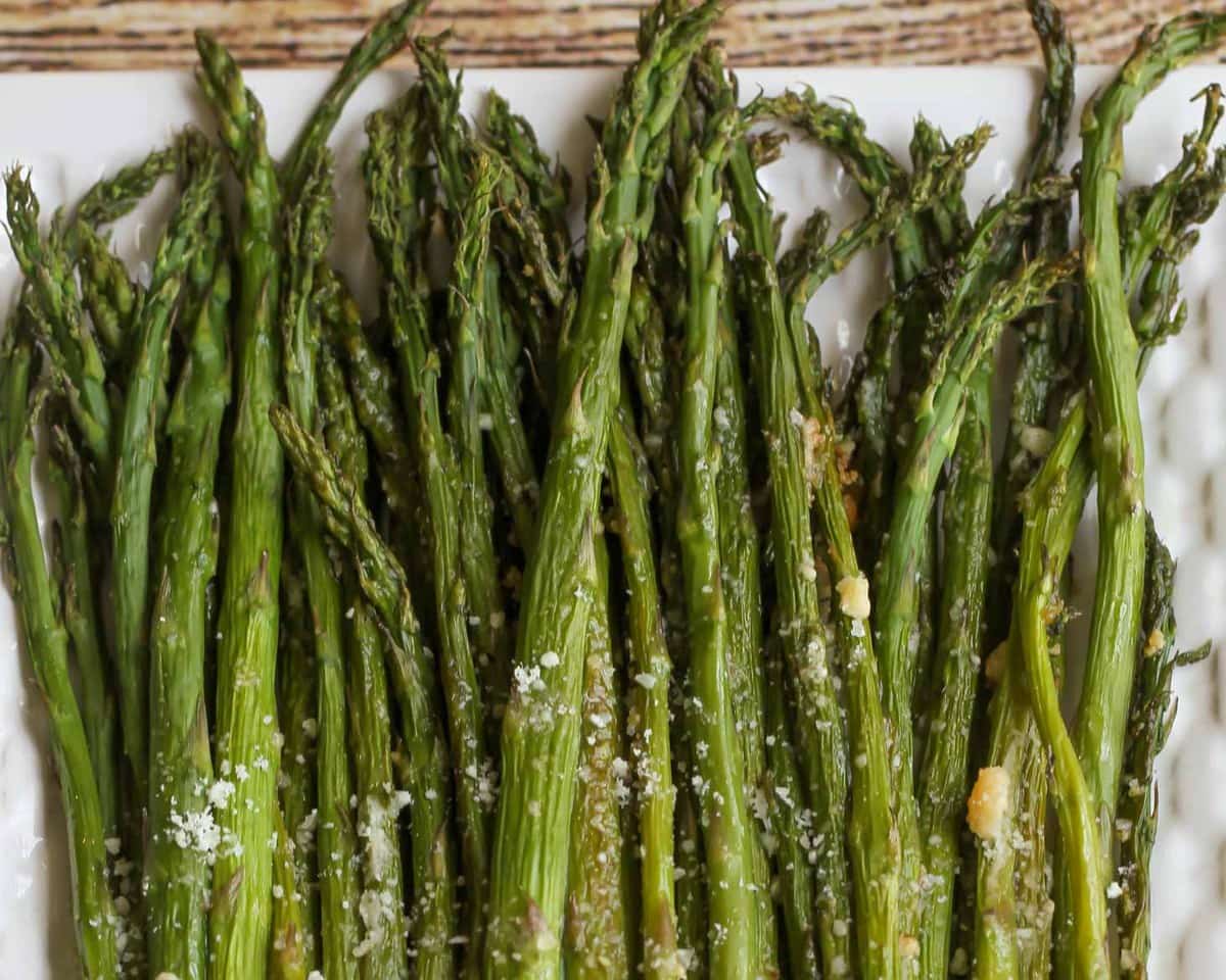 Baked Parmesan Asparagus served on a white platter.