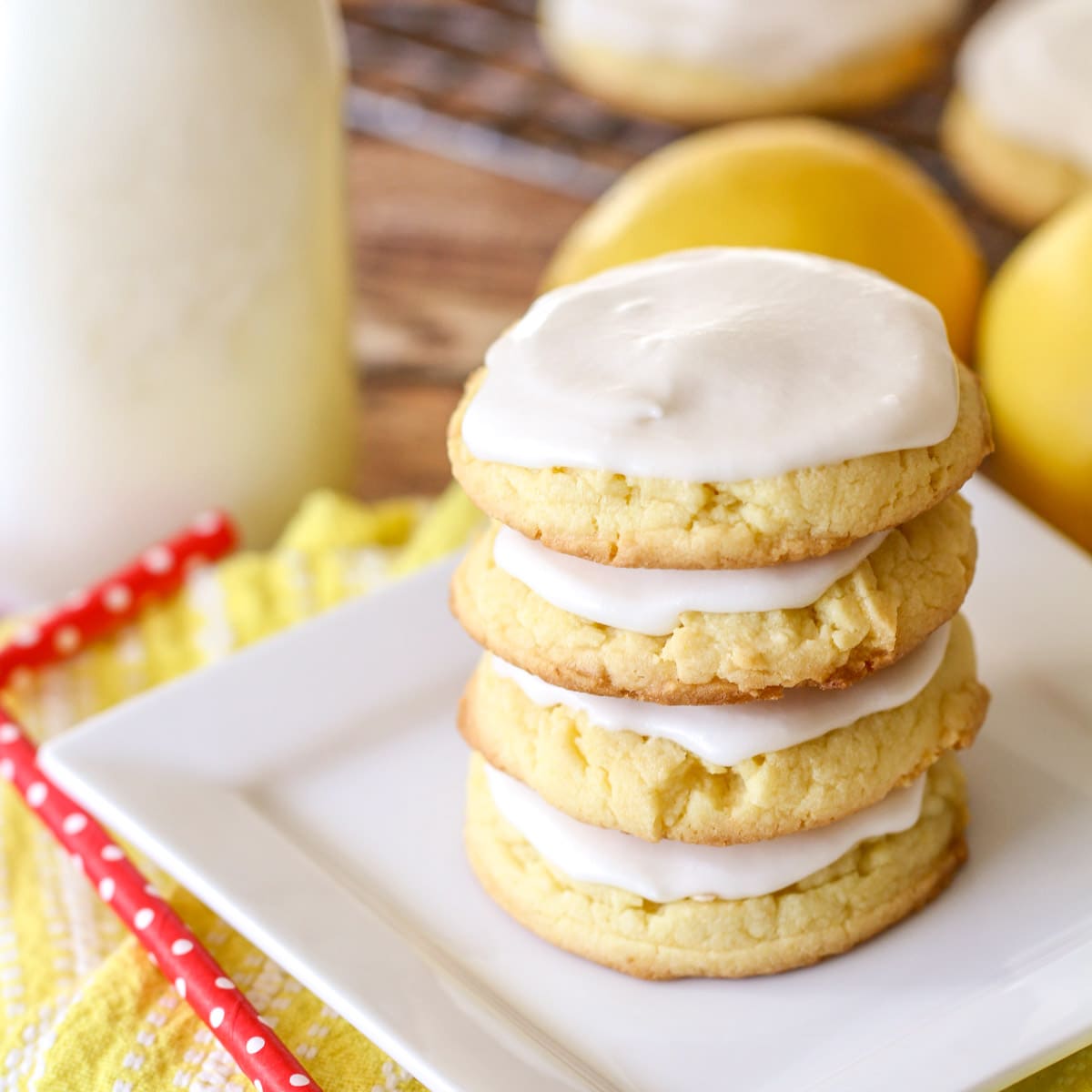 Frosted lemon cookie recipe stacked on a white plate