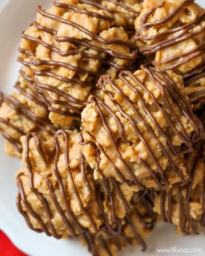 Sweet and salty chex mix - chocolate drizzled peanut butter chews stacked on a plate.