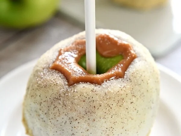Apple Pie Caramel Apples {Disney Copycat Recipe} ~ tart Granny Smith apples are dipped in chewy caramel, coated in white chocolate, sprinkled with cinnamon sugar, and then finished off with pie crust crumbs for your favorite Disney treat easily made at home for a fraction of the price! | FiveHeartHome.com for LilLuna.com
