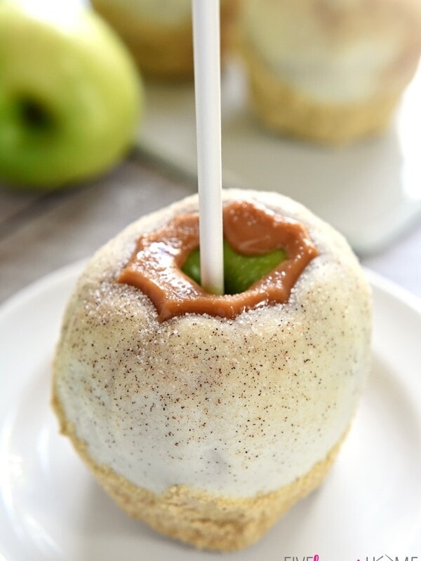 Apple Pie Caramel Apples {Disney Copycat Recipe} ~ tart Granny Smith apples are dipped in chewy caramel, coated in white chocolate, sprinkled with cinnamon sugar, and then finished off with pie crust crumbs for your favorite Disney treat easily made at home for a fraction of the price! | FiveHeartHome.com for LilLuna.com
