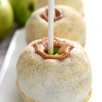 Apple Pie Caramel Apples {Disney Copycat Recipe} ~ tart Granny Smith apples are dipped in chewy caramel, coated in white chocolate, sprinkled with cinnamon sugar, and then finished off with pie crust crumbs for your favorite Disney treat easily made at home for a fraction of the price! | FiveHeartHome.com for LilLuna.com