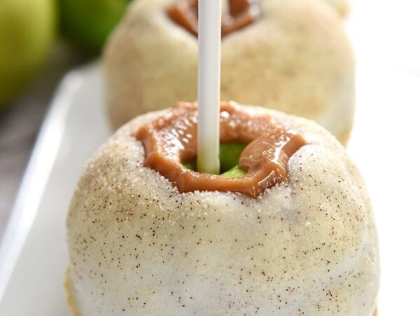 Apple Pie Caramel Apples {Disney Copycat Recipe} ~ tart Granny Smith apples are dipped in chewy caramel, coated in white chocolate, sprinkled with cinnamon sugar, and then finished off with pie crust crumbs for your favorite Disney treat easily made at home for a fraction of the price! | FiveHeartHome.com for LilLuna.com