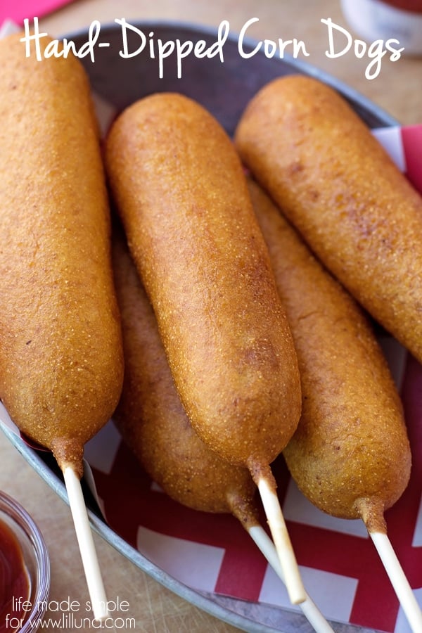 Corn Dogs piled in a metal bowl.